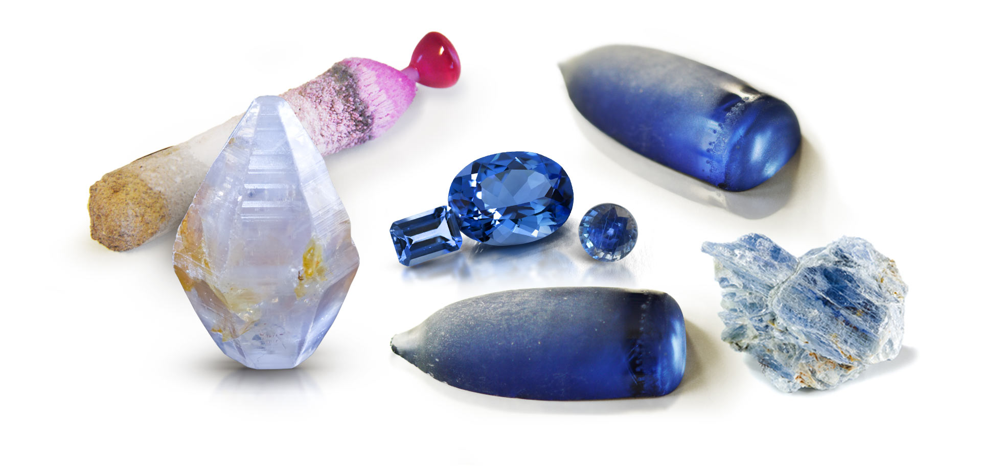 Three man-made corundum boules, one natural bipyramidal sapphire rough, three faceted corundum gemstones and one kyanite crystal